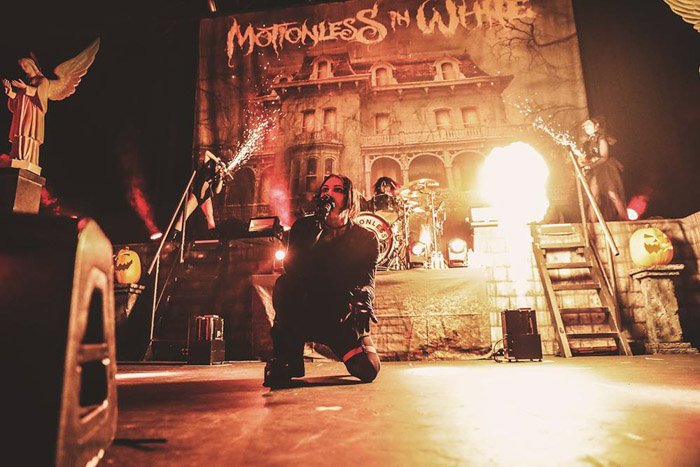 Вокалист группы Motionless in White, с пиротехникой, нарушающей освещение.