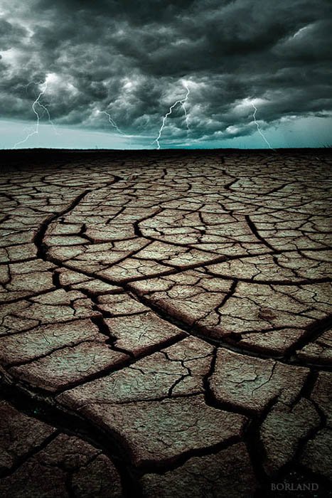 Death Valley cracked sand photo with lightning storm composited in Photoshop in the background