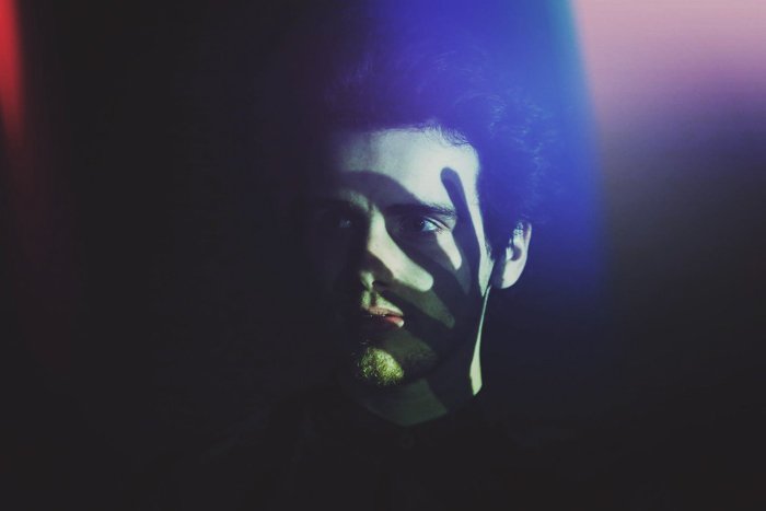 Ночной портрет мужчины с тенью от руки на лице