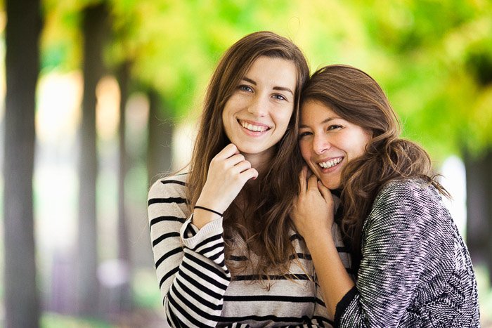 An outdoor portrait of two female friends hugging casually in Brhl, Germany 