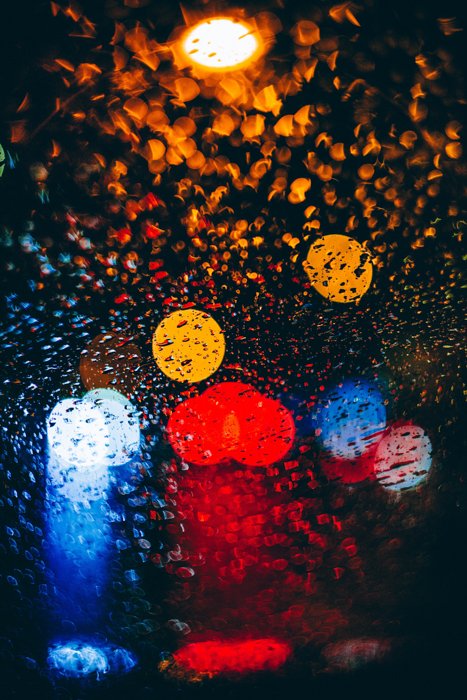 Абстрактная фотография дождя с цветными огнями боке