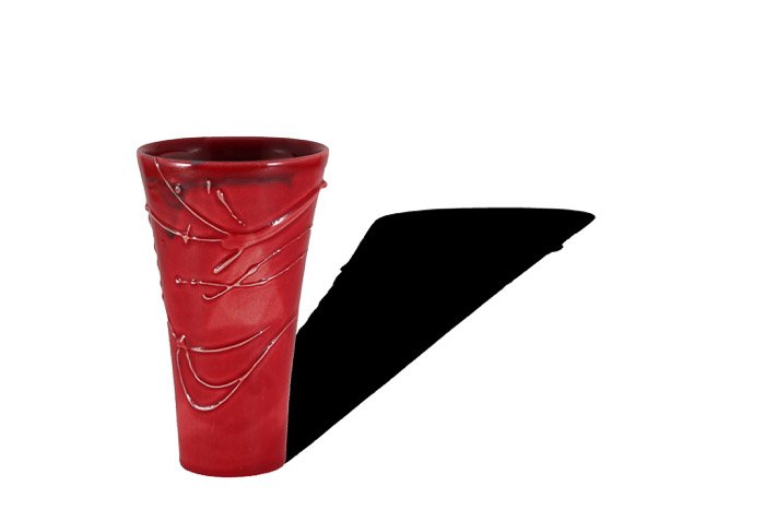 A product photography shot of the red vase with a strong shadow
