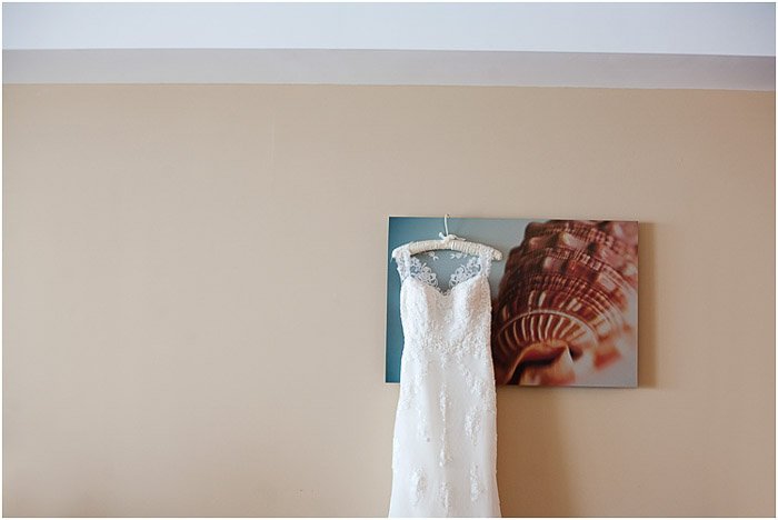 A wedding dress hanging from the mounted photo print - destination wedding tips