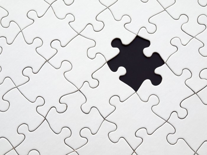 A stock image of the white jigsaw puzzle with one piece missing - stock images