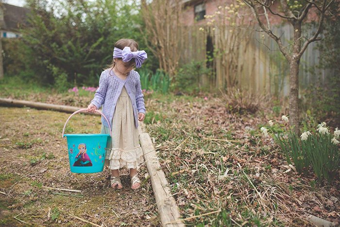 A sweet Easter portrait of the little girl on an Easter egg hunt