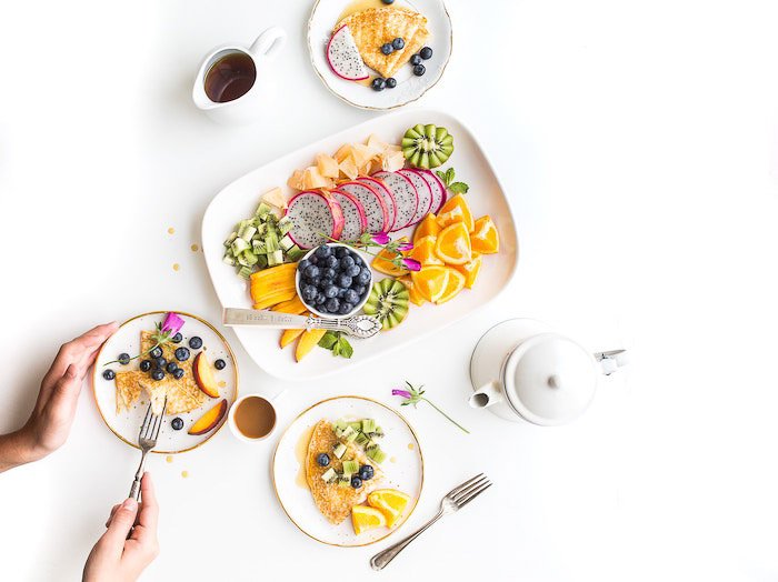 A bright and airy food flat lay of plates of fruit salad - - food photography examples