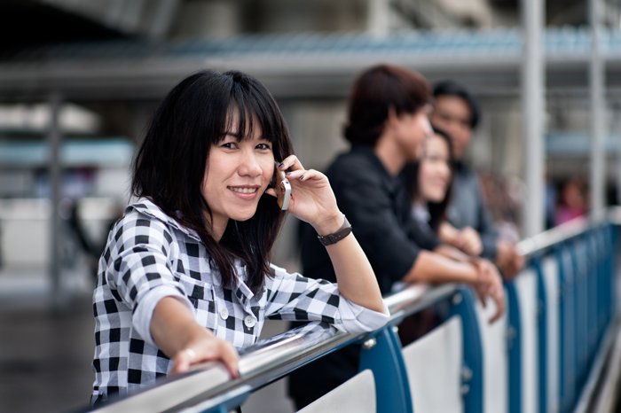 A stock photography portrait of a female model talking on the phone