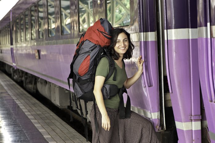 Женщина-путешественница садится на поезд - стиль стоковой фотографии