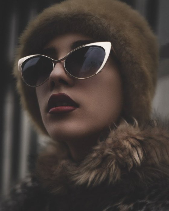 A beauty editorial fashion shot of the female model posing in sunglasses and fur - fashion photography types