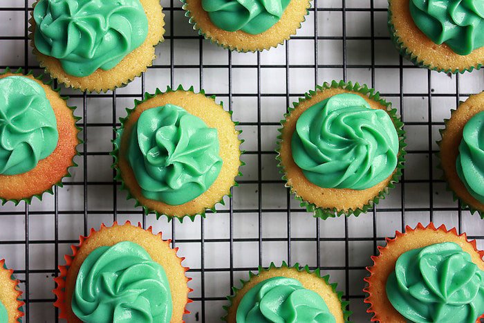 Overhead cup cake photo of the plate of green frosted cakes on the wire rack 