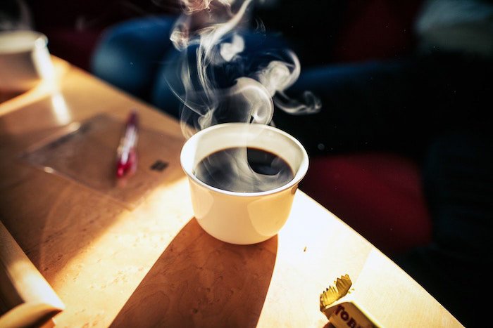 Белая чашка горячего кофе, окруженная паром - как фотографировать кофейный пар