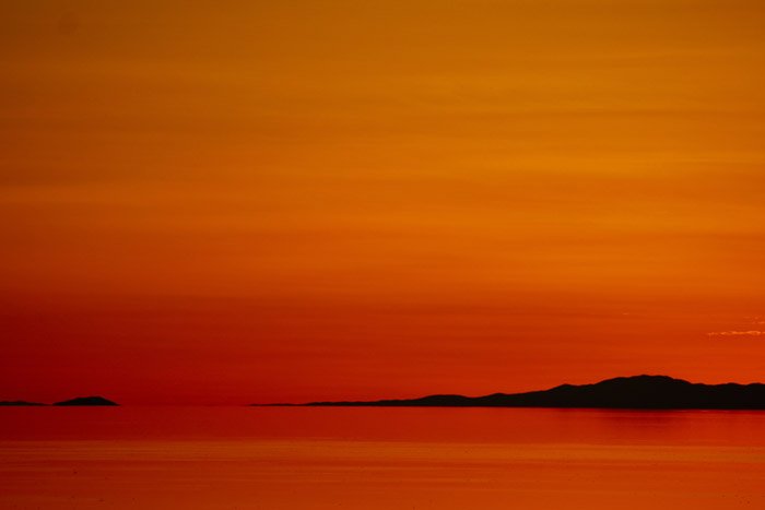 a beautiful orange and red colored coastal scene at sunset- stunning landscape photos