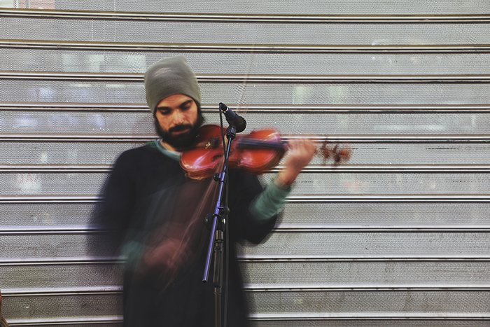 Motion blur photo of the man playing violin