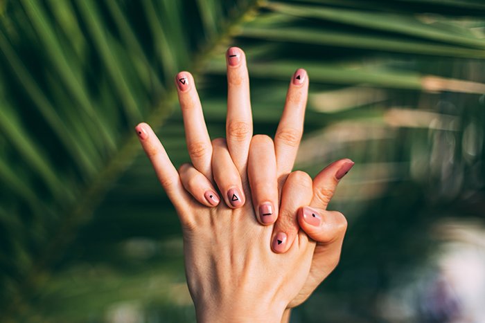 cool nail photography of a female models hands with painted nails