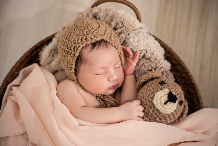 DIY newborn photography of the newborn with the teddybear