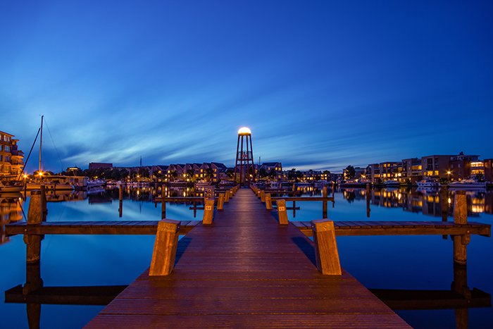 Long exposure time lapse photo of a wooden pier at night