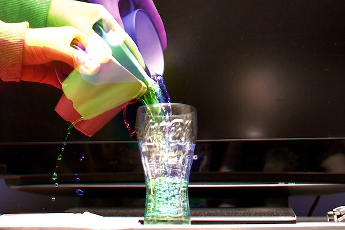 Харрис эффект разноцветных рук, наливающих разноцветную воду в стакан