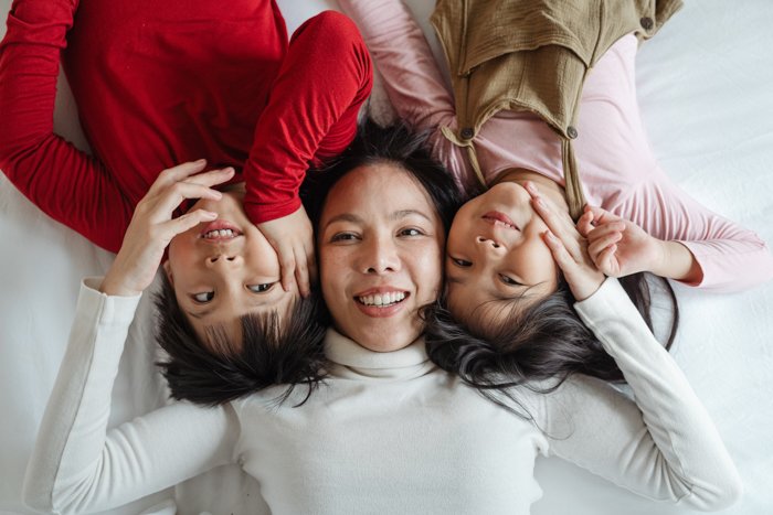 три женщины сфотографированы на кровати сверху