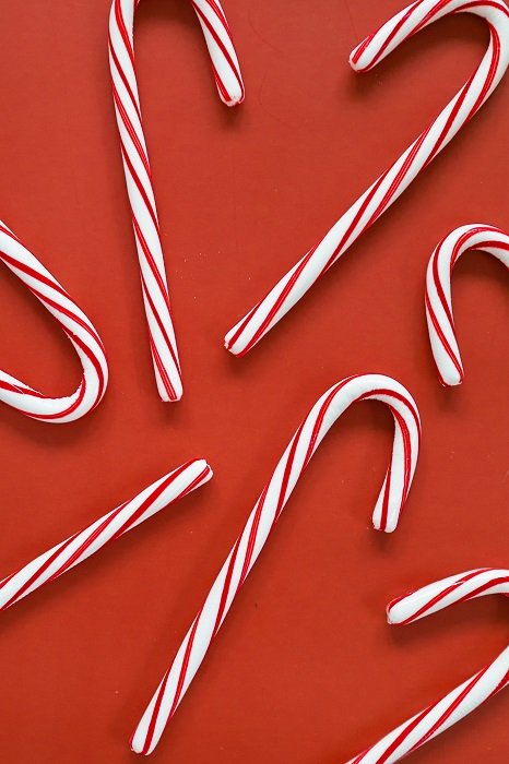 Christmas flat lay of candy canes on red background