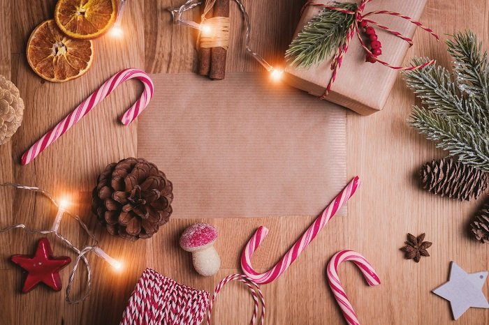 Christmas flat lay with natural objects candy canes and gift wrapping items