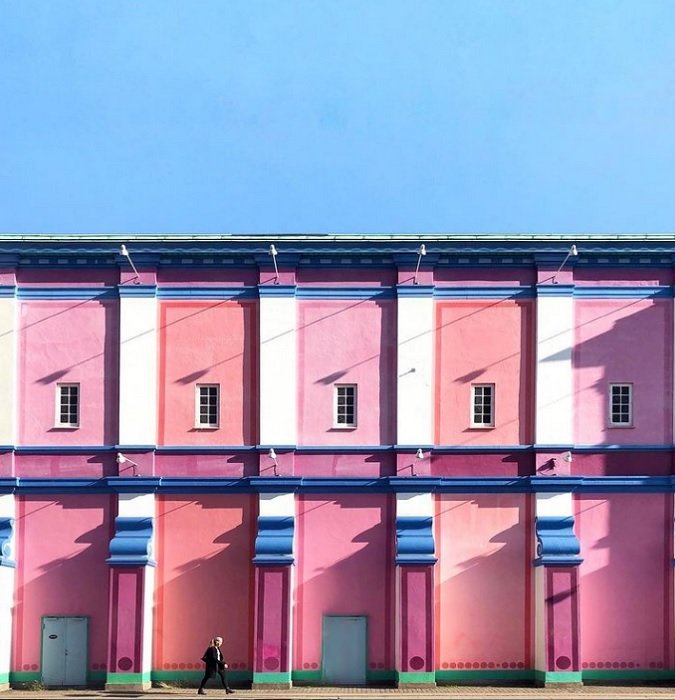 цвет в фотографии: здание, окрашенное в розовые и красные цвета, контрастирует с холодным голубым небом над ним
