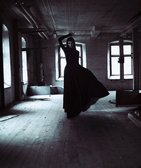 страшная фотография ужасов: одержимая женщина в черном платье стоит в заброшенном здании с привидениями