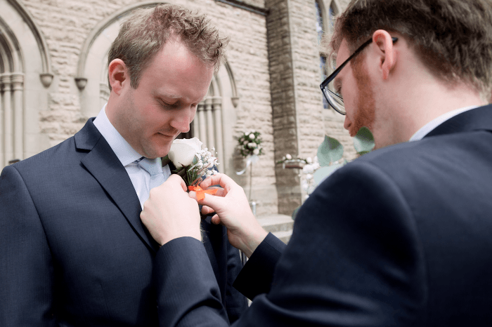wedding shot tip: Groom having his buttonhole adjusted