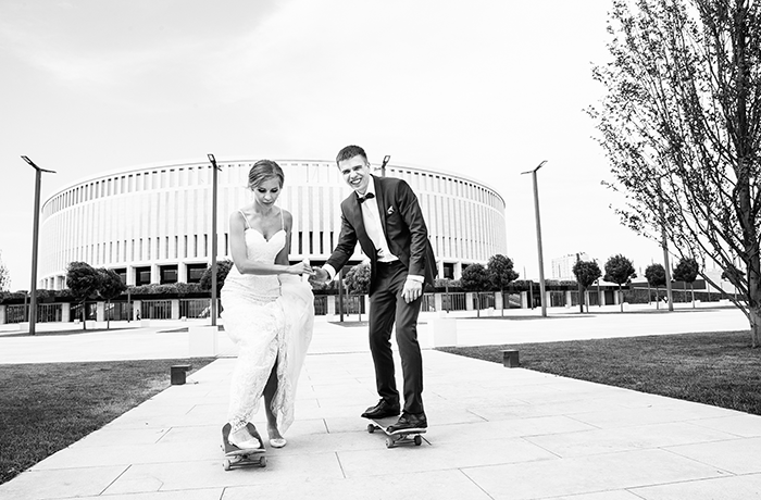 черно-белое изображение невесты и жениха на скейтборде