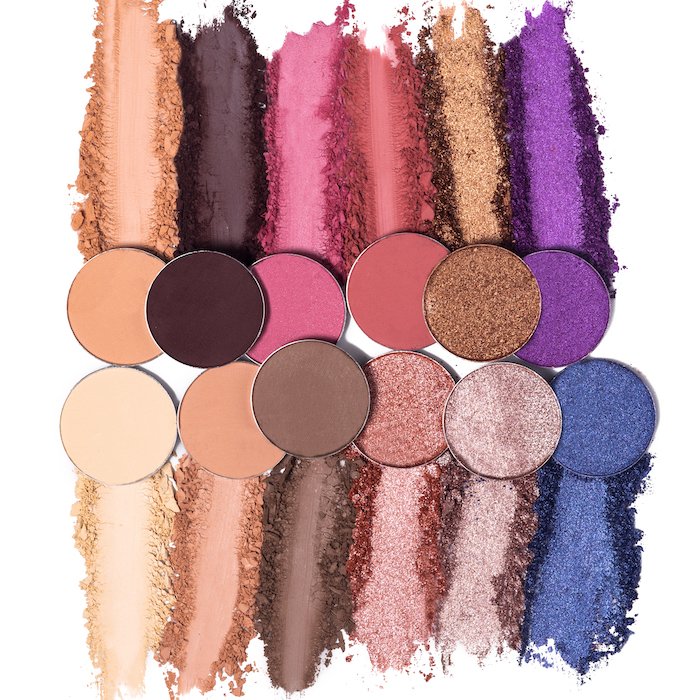 A flat lay product photography image of eye shadow in the array of colors