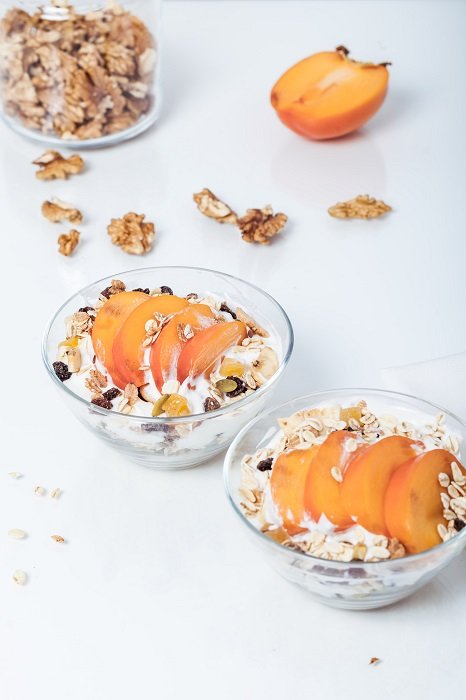 Food Photography tips: two bowls of peach parfait captured on the white table