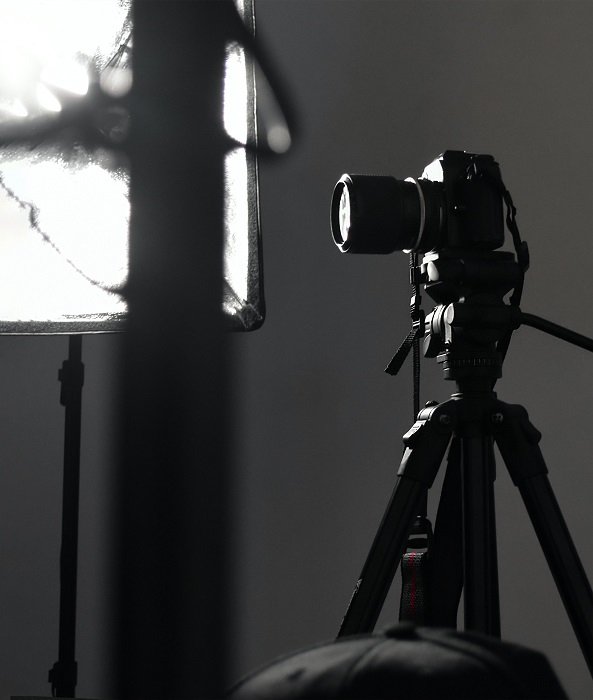 Камера на штативе в студии с большим светом