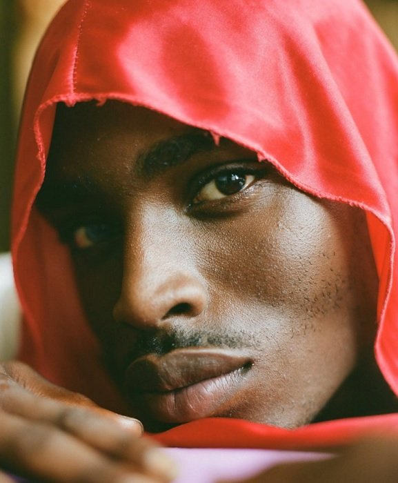 Close portrait of the man in a red hood