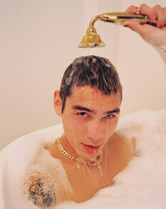 портрет мужчины с золотой цепью, принимающего пенную ванну