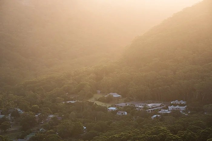 Hazy edited landscape photo of the village on the woodland hillside