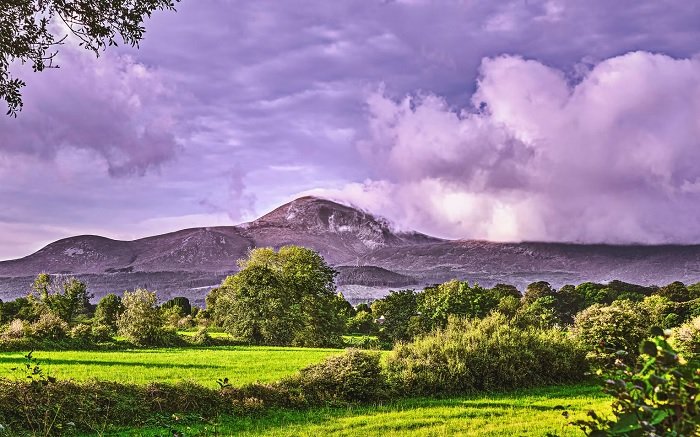 High Dynamic range landscape photo of the mountain behind a field